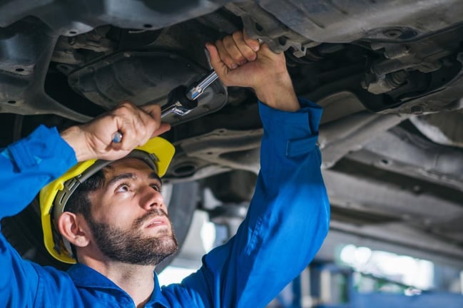 mechanic-repairing-car-damage-at-auto-shop